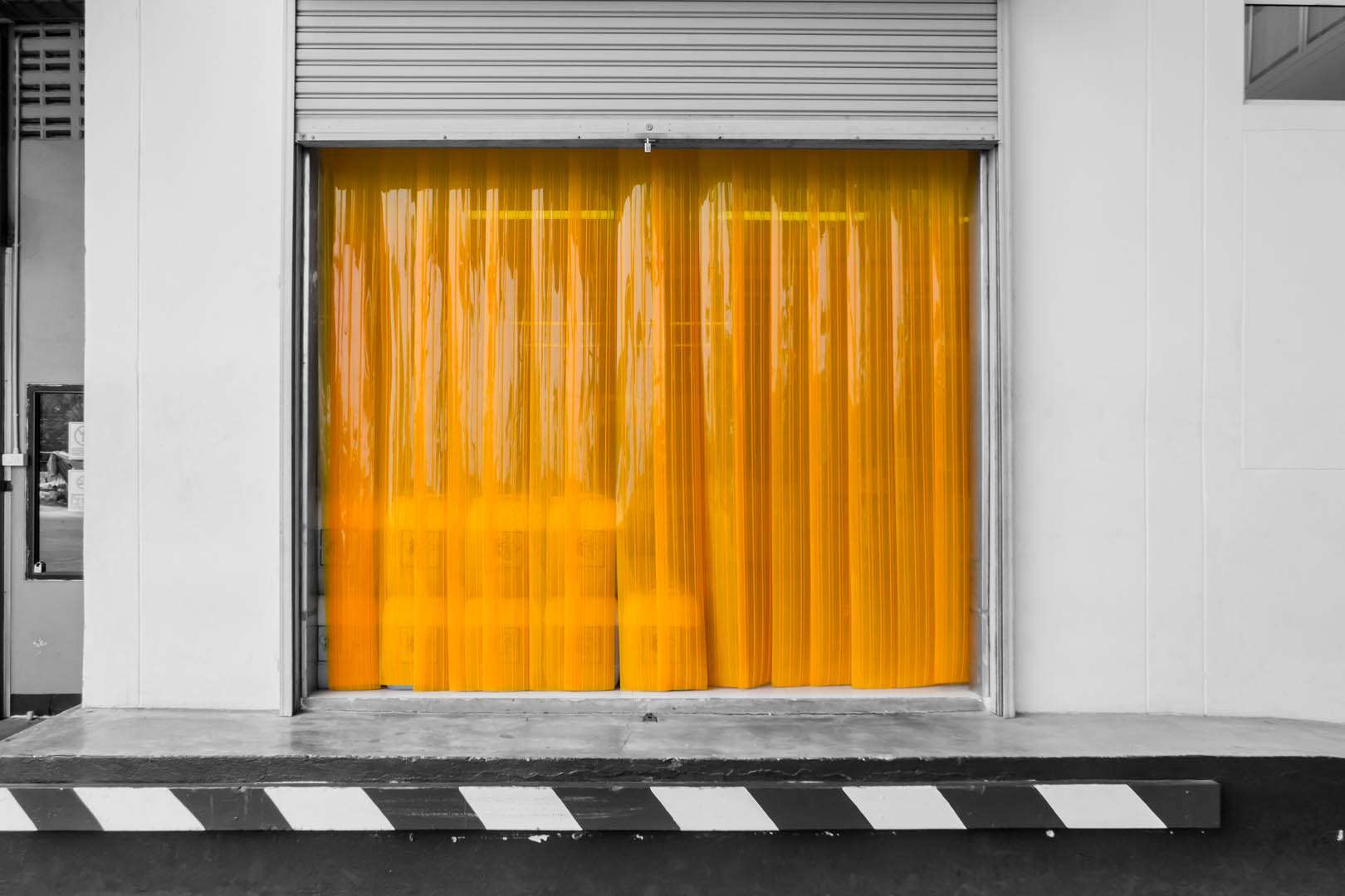 Warehouse gate loading area with PVC strip curtain or plastic strip doors.